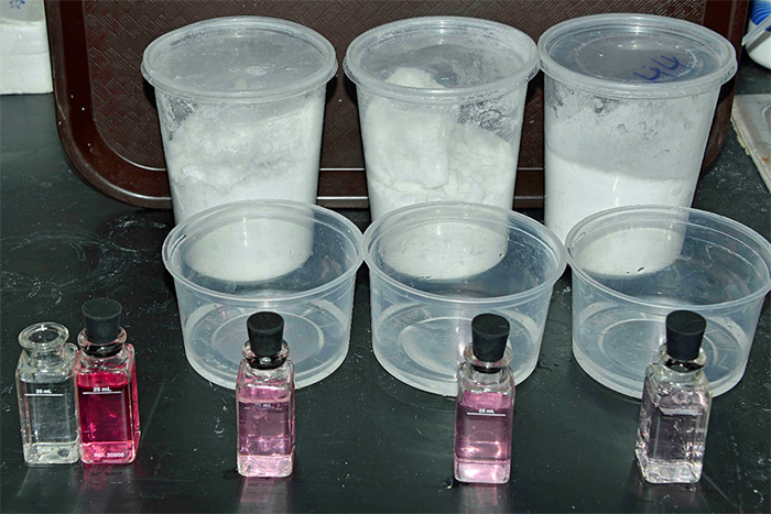 DPD chlorine test on three brands of sea salt – left to right; brands A, B, and C. Lighter pink color indicates less chlorine present after mixing. The dark pink vial on the left is the tap water control.